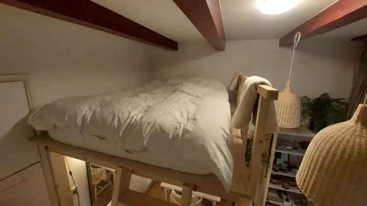 Room with sleeping loft next to central station