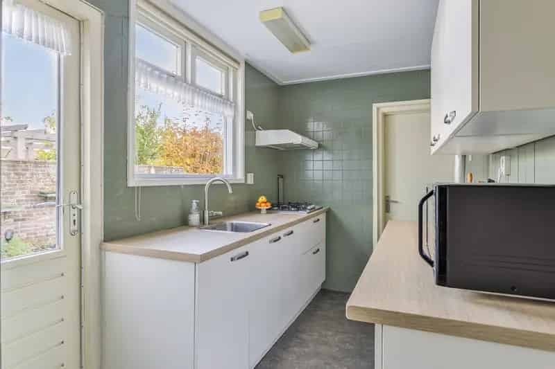 Tussenwoning Zaamslag: Ruime Tuin Garage 3 slaapkamers